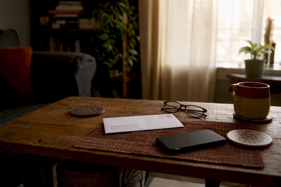 Desk with unopened tax notice and glasses