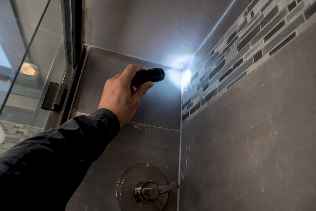 Hand inspecting window and door hardware for punch list